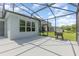 Spacious screened-in backyard patio with a grill, perfect for outdoor entertaining and relaxation at 2167 Pearl Cider St, Orlando, FL 32824