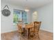 Dining room with wood table, chairs, and view of pool through bright window at 2167 Pearl Cider St, Orlando, FL 32824