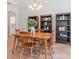 Cozy dining room featuring wood floors, a traditional table, and stylish bookshelves at 2167 Pearl Cider St, Orlando, FL 32824