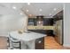 Modern kitchen features dark cabinets, stainless steel appliances, and a light countertop island at 2167 Pearl Cider St, Orlando, FL 32824