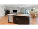 Open layout kitchen features a modern island with a sink, stainless steel appliances, and a breakfast nook at 2167 Pearl Cider St, Orlando, FL 32824