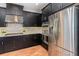 Stylish kitchen featuring stainless steel appliances, modern cabinetry, and wood-look tile flooring at 2167 Pearl Cider St, Orlando, FL 32824