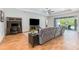 Spacious living room features a large sectional sofa, wood floors, and access to the outdoor patio at 2167 Pearl Cider St, Orlando, FL 32824