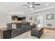 Open-concept living area featuring dark cabinets in the kitchen, wood floors, and neutral walls at 2167 Pearl Cider St, Orlando, FL 32824