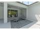 Covered patio featuring Adirondack chairs, a small table, and string lights for relaxing outdoor living at 2167 Pearl Cider St, Orlando, FL 32824