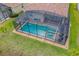 Aerial view of a private screened-in pool and spa with a brick paver patio and red tile roof at 2173 Lake Side Ave, Davenport, FL 33837