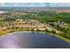 An aerial view captures the community by a lake, with expansive landscapes, and residential charm at 2173 Lake Side Ave, Davenport, FL 33837