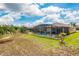 Aerial view of a screened-in pool, backyard, and lush green lawn in a residential neighborhood at 2173 Lake Side Ave, Davenport, FL 33837