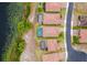 An aerial view of homes along a lakefront showing tile roofs, screened lanais, and well-maintained landscaping at 2173 Lake Side Ave, Davenport, FL 33837