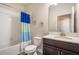 Well-lit bathroom features a shower-tub combo with colorful shower curtain, and vanity with white countertop at 2173 Lake Side Ave, Davenport, FL 33837