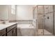 Bathroom with a soaking tub, shower with glass door, and a single sink at 2173 Lake Side Ave, Davenport, FL 33837