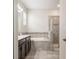 Bathroom with double vanity, large tub, and glass-enclosed shower at 2173 Lake Side Ave, Davenport, FL 33837
