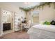 Bright bedroom with a ceiling fan, shelves, decor and an adjacent bathroom at 2173 Lake Side Ave, Davenport, FL 33837