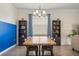 Inviting dining area with a large wood table, stylish decor, and blue accent wall at 2173 Lake Side Ave, Davenport, FL 33837
