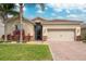 Charming home featuring a tile roof, a two-car garage and tropical landscaping at 2173 Lake Side Ave, Davenport, FL 33837