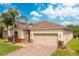 Well-maintained home with a tile roof, spacious two-car garage, and attractive landscaping at 2173 Lake Side Ave, Davenport, FL 33837