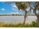 Lake view with calm water, lily pads, and trees with hanging moss with homes in the distance at 2173 Lake Side Ave, Davenport, FL 33837