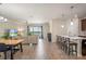 Open-concept living room with wood floors, large window views, and pendant lighting over the kitchen bar at 2173 Lake Side Ave, Davenport, FL 33837
