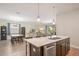 Bright living space with wood floors, open floor plan, and views of the patio with pool beyond at 2173 Lake Side Ave, Davenport, FL 33837