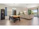 Spacious living room with a wood dining table, comfortable seating, and sliding glass doors to the lanai at 2173 Lake Side Ave, Davenport, FL 33837