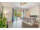 Bright living room featuring wood floors, neutral paint, and sliding glass doors to outdoor pool at 2173 Lake Side Ave, Davenport, FL 33837