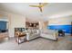 Open-concept living room offering views to the dining room and kitchen with dark wood cabinets at 2173 Lake Side Ave, Davenport, FL 33837