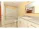 Bright bathroom featuring a bathtub/shower combination, white vanity, and neutral tile flooring at 2214 Metropolitan Way # 1032, Orlando, FL 32839