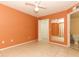 Bedroom with a ceiling fan, mirror, and an en-suite bathroom at 2214 Metropolitan Way # 1032, Orlando, FL 32839