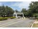 Community entrance gate with white guard house and landscaping at 2214 Metropolitan Way # 1032, Orlando, FL 32839