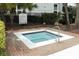 A relaxing hot tub surrounded by brick and lush landscaping is adjacent to the community pool at 2214 Metropolitan Way # 1032, Orlando, FL 32839