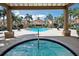 Community hot tub framed by a pergola offers a view of the pool and surrounding buildings at 2214 Metropolitan Way # 1032, Orlando, FL 32839