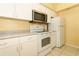 Modern kitchen features stainless steel microwave and ample counter space at 2214 Metropolitan Way # 1032, Orlando, FL 32839