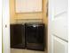 Laundry room featuring modern washer and dryer, shelves, and cabinet at 2214 Metropolitan Way # 1032, Orlando, FL 32839