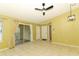 Living room with ample natural light, tile floors, sliding doors to a balcony, and a ceiling fan at 2214 Metropolitan Way # 1032, Orlando, FL 32839