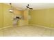 Open-concept living area and kitchen featuring tile floors and modern appliances at 2214 Metropolitan Way # 1032, Orlando, FL 32839