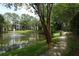 Scenic view of pond with water fountain and a tree-lined sidewalk creating a peaceful environment at 2214 Metropolitan Way # 1032, Orlando, FL 32839