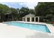 Community pool showcasing crystal clear water, surrounded by a fence, and lush landscaping at 2214 Metropolitan Way # 1032, Orlando, FL 32839