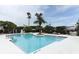 A large community pool, surrounded by palm trees and greenery, offers a refreshing outdoor escape at 2214 Metropolitan Way # 1032, Orlando, FL 32839