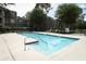 Community swimming pool and pool deck, surrounded by green landscaping and seating at 2214 Metropolitan Way # 1032, Orlando, FL 32839