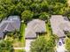 Aerial view of home featuring mature trees, brick driveway and an attached two-car garage at 224 Bluestone Pl, Casselberry, FL 32707