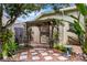 Private backyard featuring a pergola, stone walkway, and lush tropical landscaping at 224 Bluestone Pl, Casselberry, FL 32707