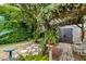 Secluded backyard oasis with a pergola, storage shed, and beautifully landscaped garden at 224 Bluestone Pl, Casselberry, FL 32707