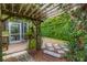 Tranquil backyard featuring a charming pergola, stepping stones, and lush greenery at 224 Bluestone Pl, Casselberry, FL 32707