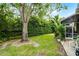 Large backyard features beautiful landscaping, healthy lawn, and screened in patio at 224 Bluestone Pl, Casselberry, FL 32707