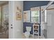 Cozy bathroom with a toilet, shower, and storage shelf, enhanced by blue accent wall at 224 Bluestone Pl, Casselberry, FL 32707