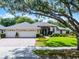 Beautiful single-story home with a three car garage and meticulously landscaped front yard at 224 Bluestone Pl, Casselberry, FL 32707