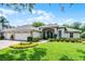 Charming single-story home with a well-manicured lawn, paver driveway and mature landscaping at 224 Bluestone Pl, Casselberry, FL 32707