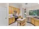 Well-equipped kitchen with stainless steel appliances, light wood cabinets, and a cozy island at 224 Bluestone Pl, Casselberry, FL 32707