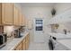 Functional laundry room with tile floors, white appliances, and convenient built-in storage at 224 Bluestone Pl, Casselberry, FL 32707
