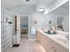 The main bathroom features double sinks, a framed mirror, a glass block shower and access to the main bedroom at 224 Bluestone Pl, Casselberry, FL 32707